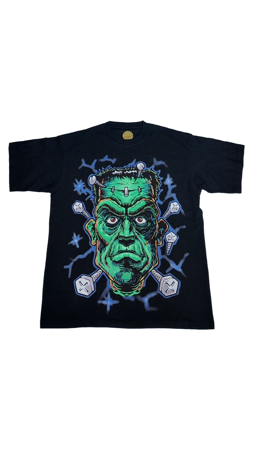 Black short sleeve t-shirt featuring a green Frankenstein graphic with bolts and lightning, perfect for Halloween.