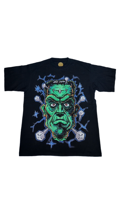 Black short sleeve t-shirt featuring a green Frankenstein graphic with bolts and lightning, perfect for Halloween.